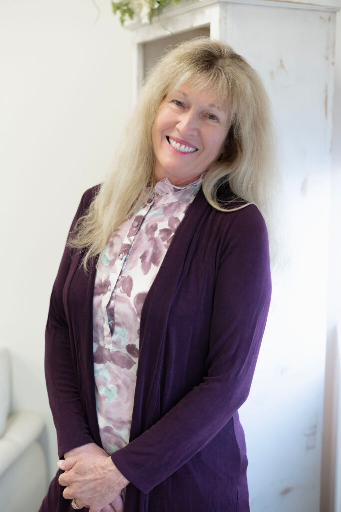 Dr. Lori Zaremski, PhD, LEP, smiling in a purple outfit at The Light Center in South Bay, California. Expert in child and family psychology, educational evaluations, and therapeutic support.
